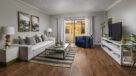 large living room with plank flooring and access to screened in patio