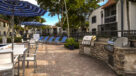 poolside grilling area with umbrella tables 