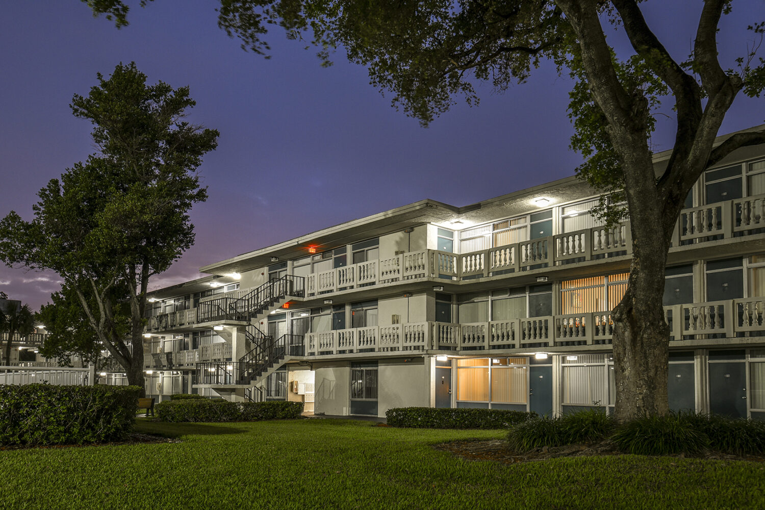 exterior photo of balconies well lit at night