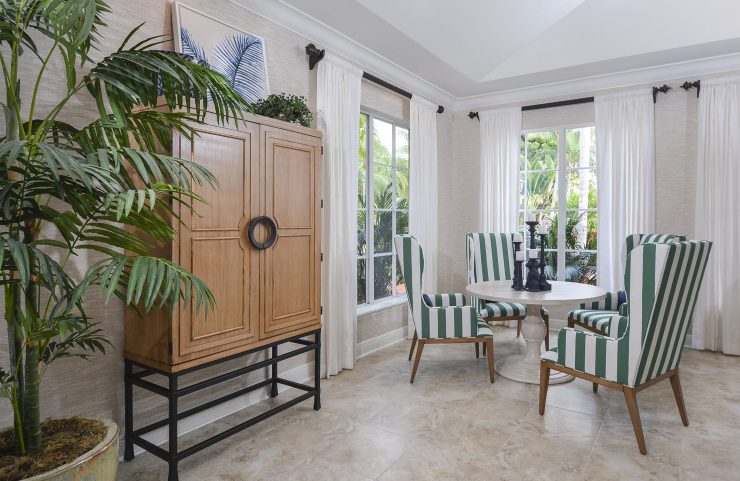clubhouse table and chairs by large windows 