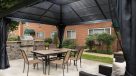 outdoor kitchen with a large table and chairs 