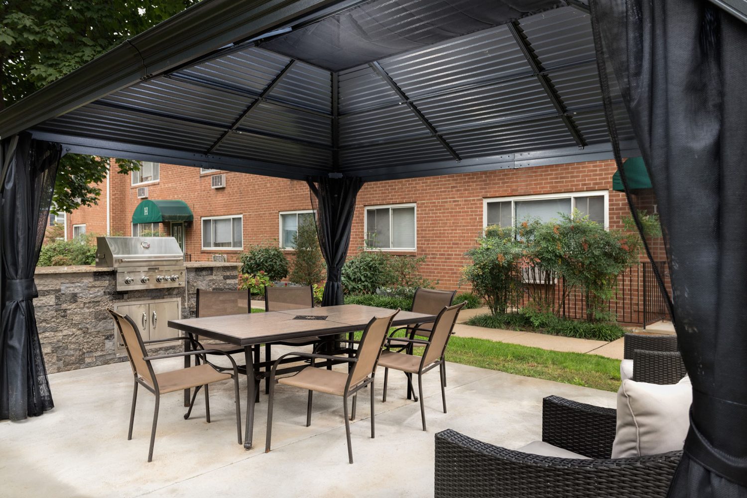outdoor kitchen with a large table and chairs
