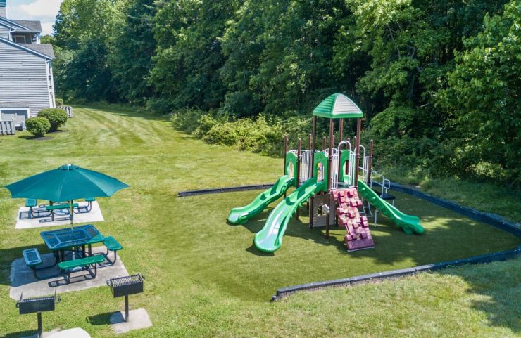 playground and grilling area with umbrella tables 