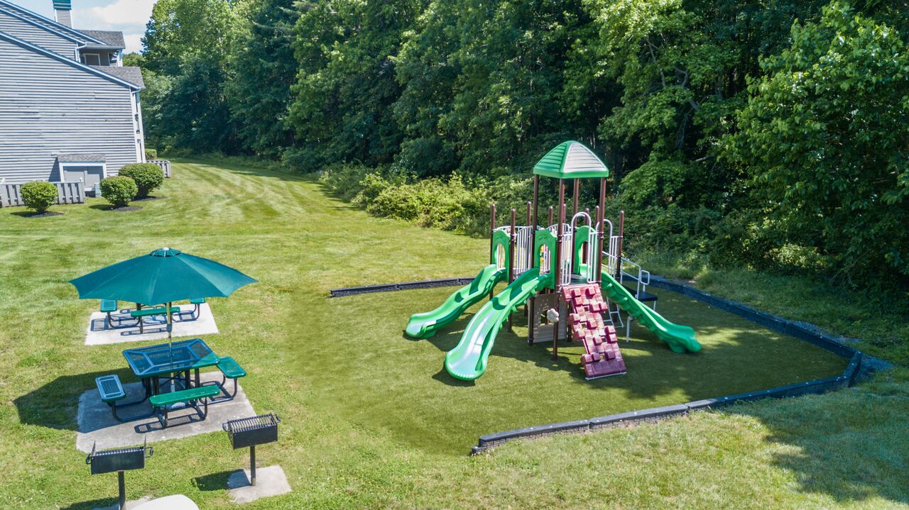 playground and grilling area with umbrella tables 