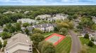 aerial view of tennis court and apartments 