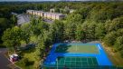 aerial view of sports court, lush trees and apartments