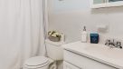 bathroom with white vanity and tub
