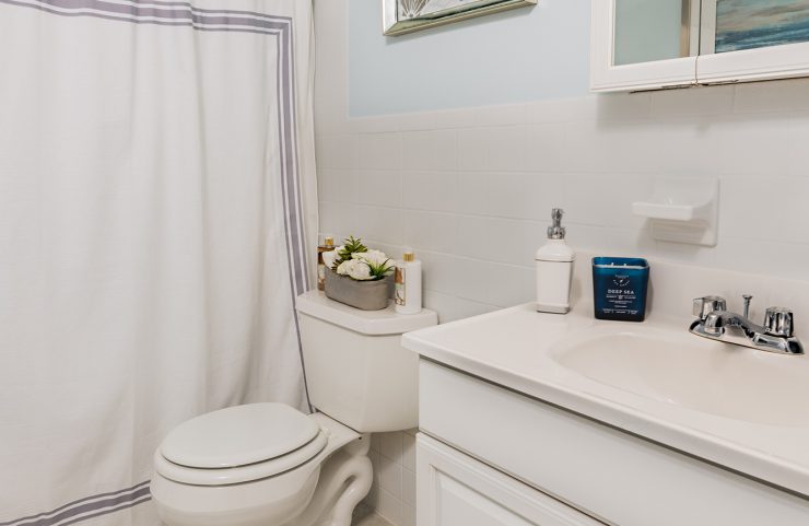 bathroom with white vanity and tub