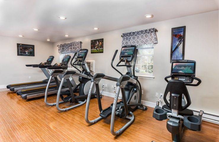 treadmills, ellipticals and bikes in fitness center 