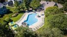 aerial view of saltwater pool surrounded by lush trees  