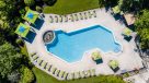 aerial view of outdoor salt water pool and cabanas
