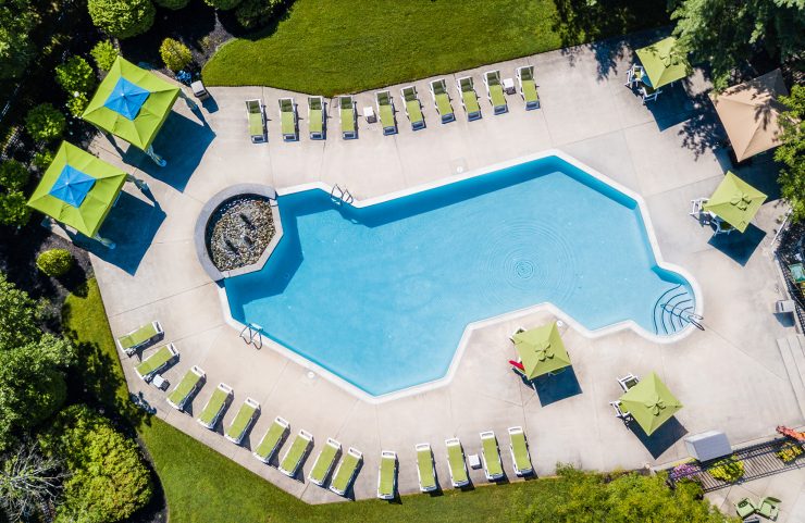 aerial view of outdoor salt water pool and cabanas
