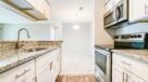 galley kitchen with white cabinets