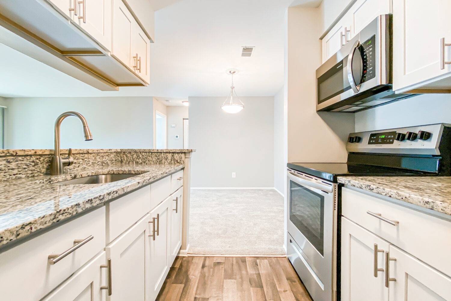 galley kitchen with white cabinets