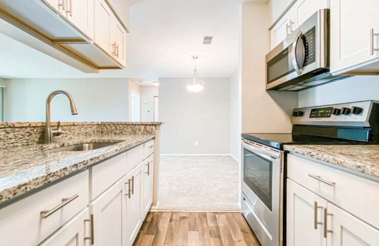 galley kitchen with white cabinets