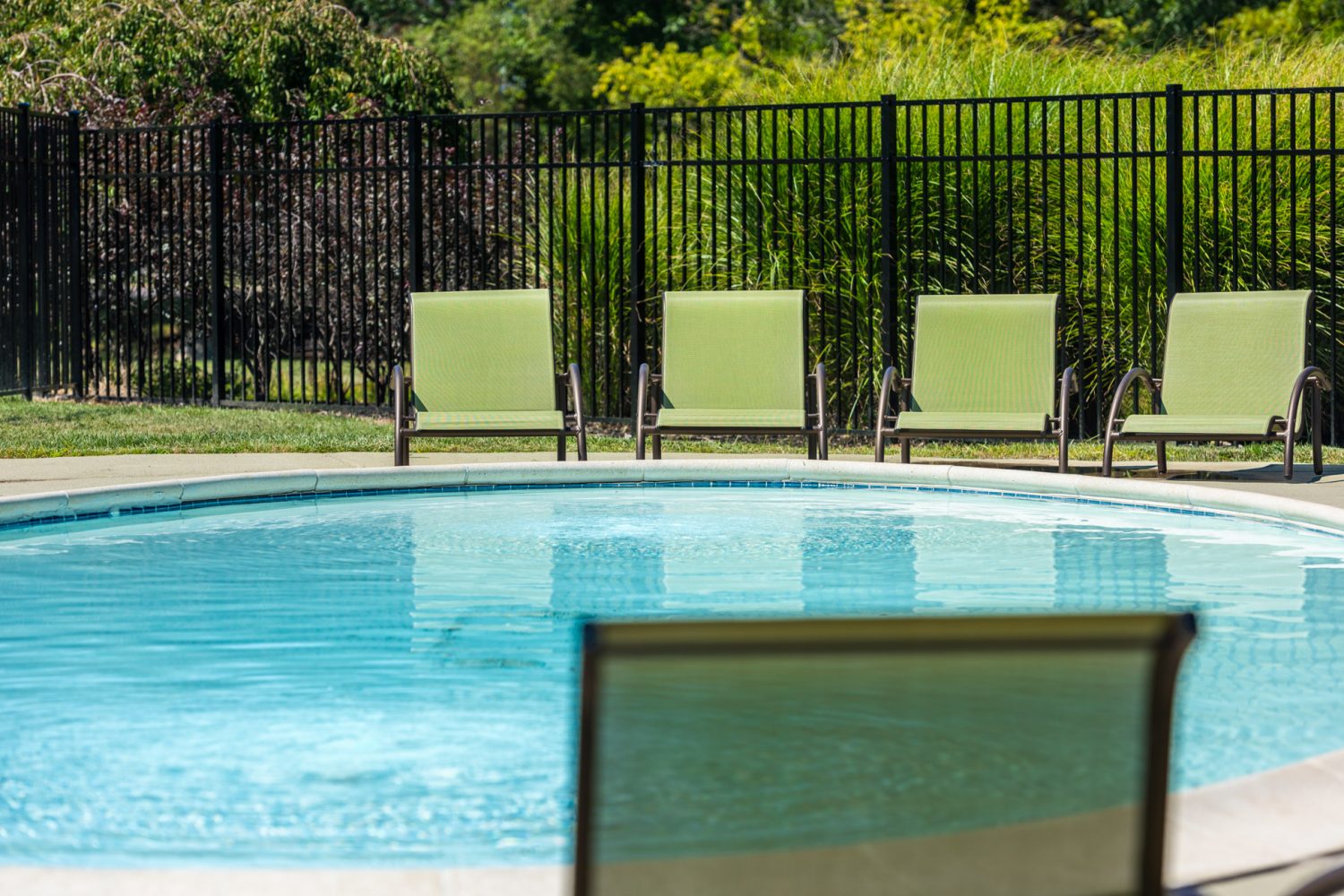 kids pool surrounded by chairs 