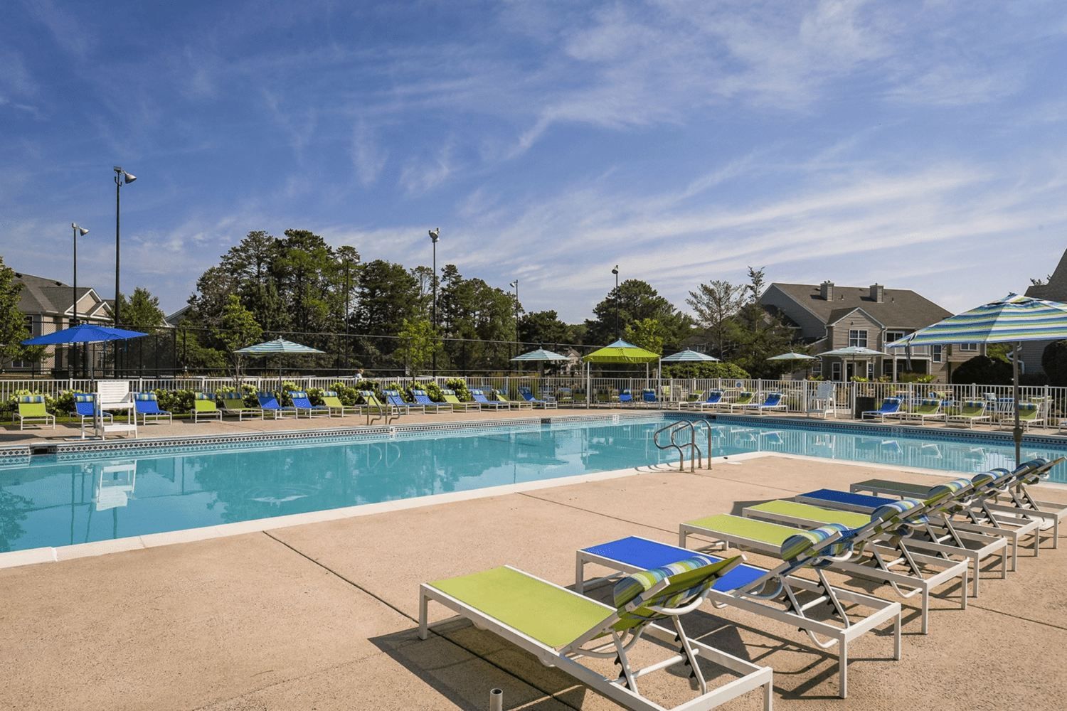 large outdoor pool with plenty of seating