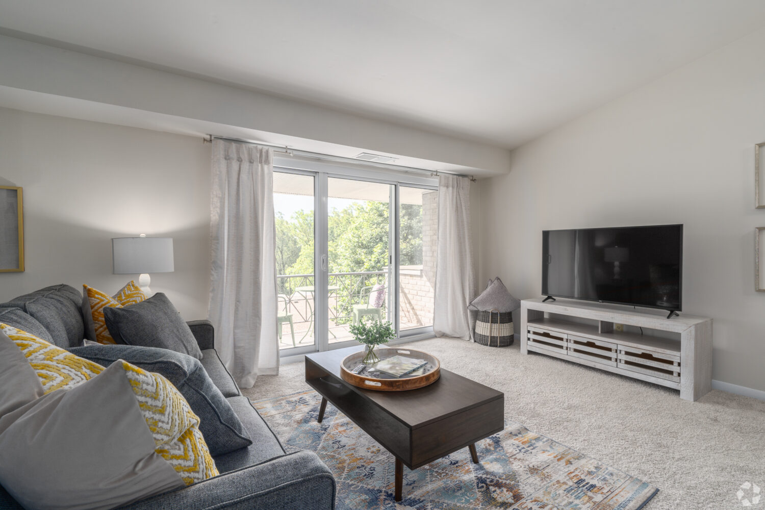 large living room with carpet and sliding door to patio