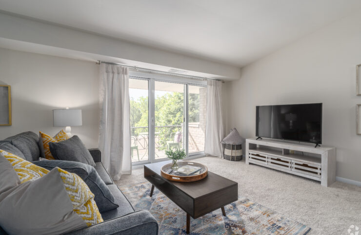 large living room with carpet and sliding door to patio