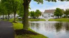 walking path around the pond with a water feature