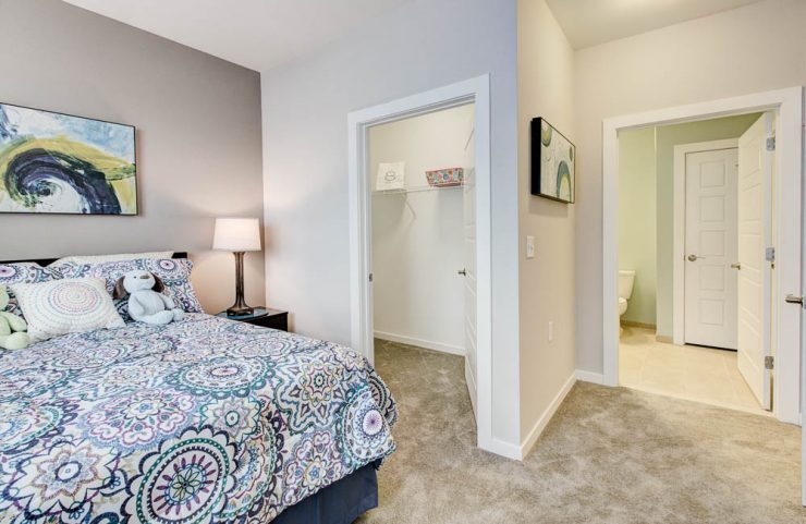 bedroom with carpet and large closet 