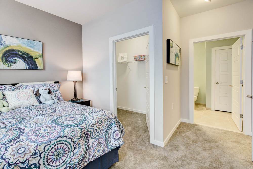bedroom with carpet and large closet 