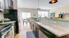 granite counterops and tile backsplash in kitchen