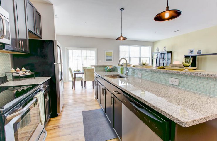 granite counterops and tile backsplash in kitchen