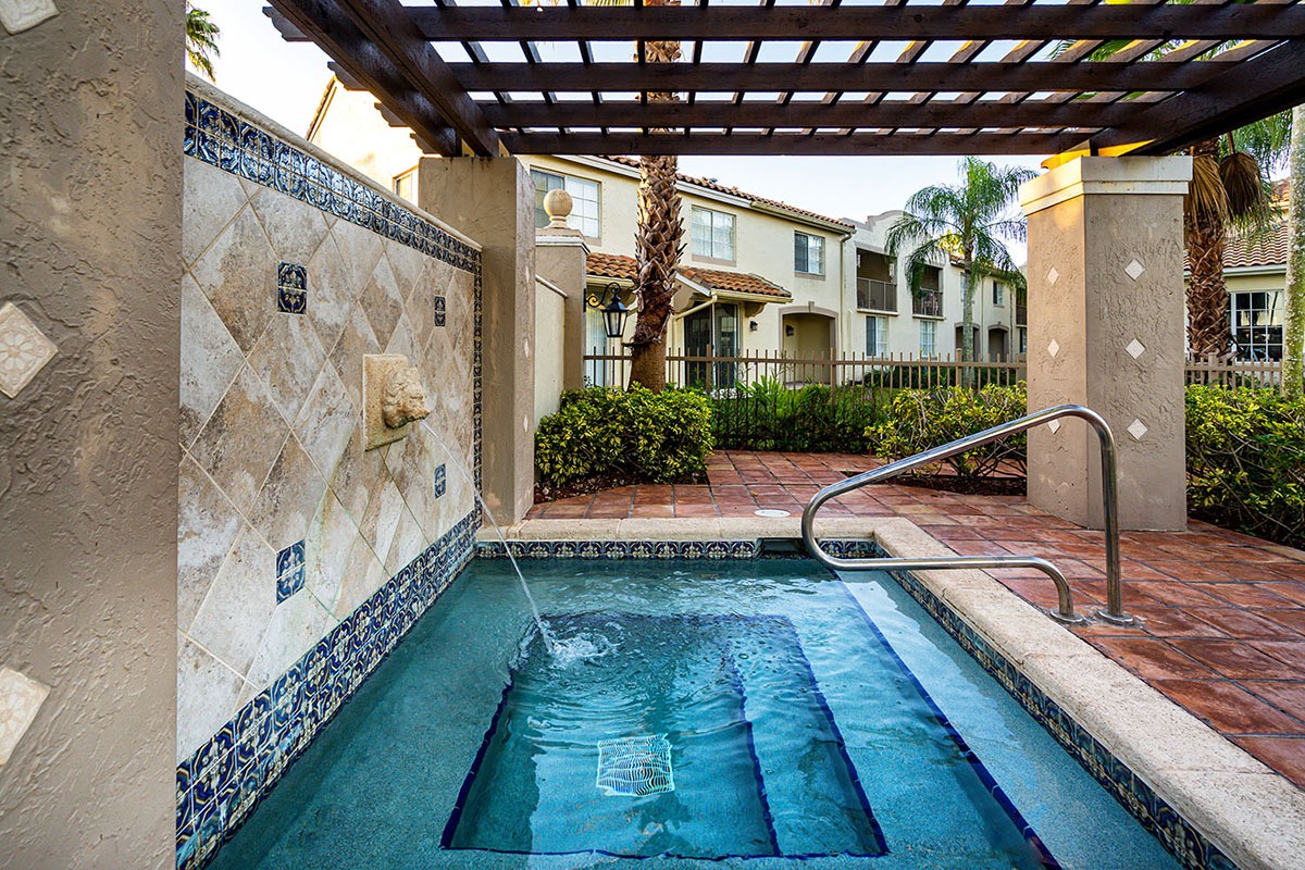 outdoor hot tub with water feature in the wall 