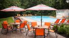 umbrella tables and chairs around the outdoor pool 