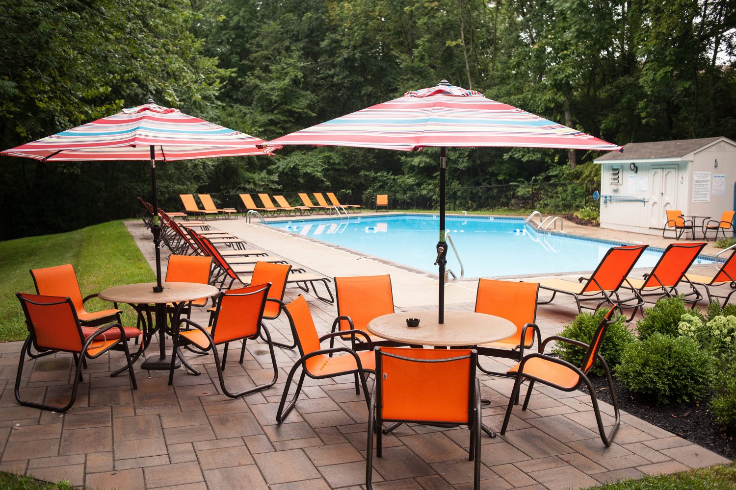 umbrella tables and chairs around the outdoor pool 