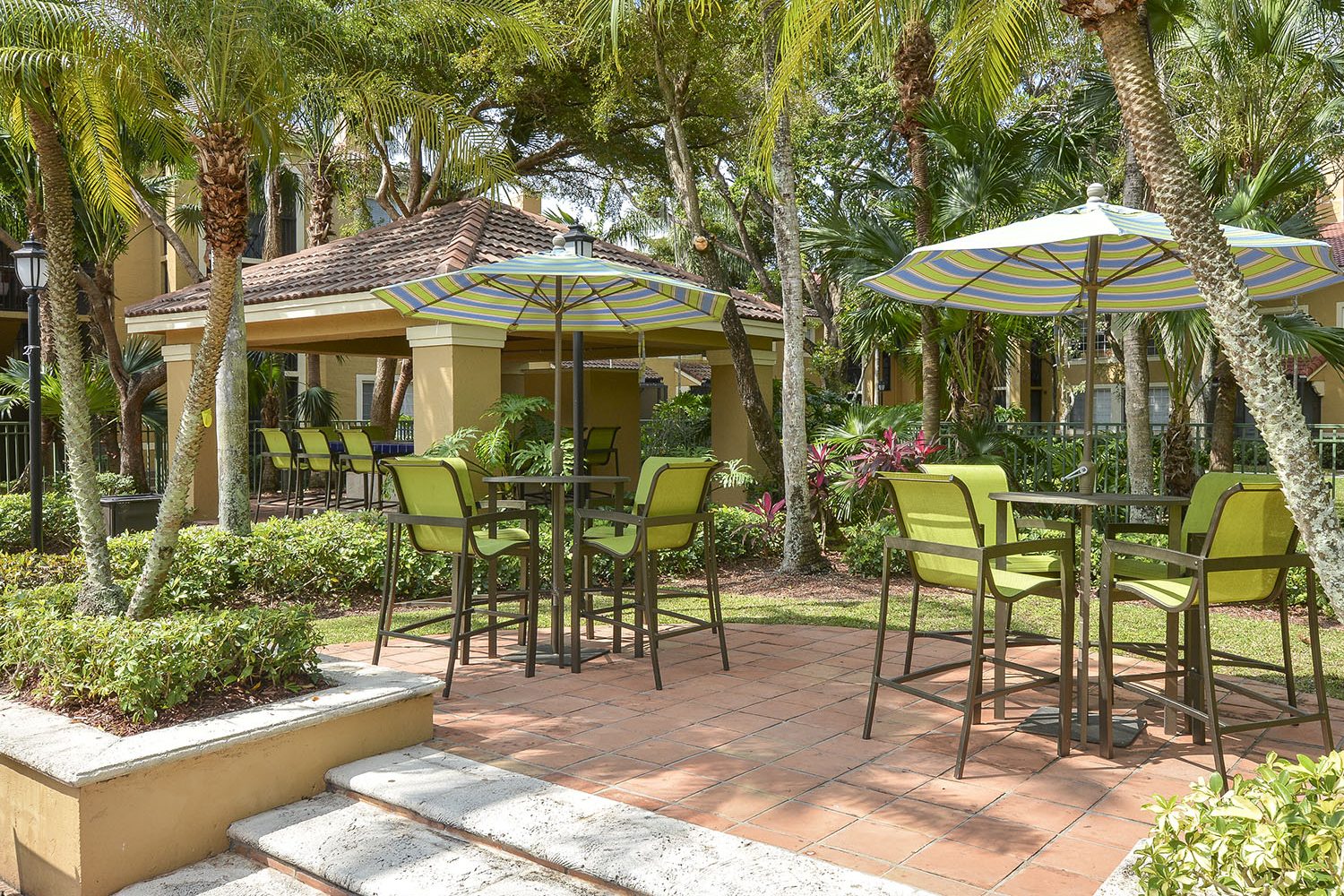 patio seating with high top umbrella tables
