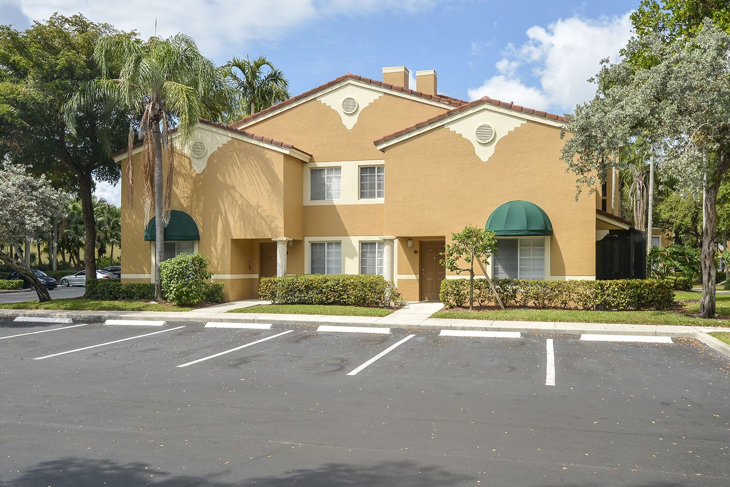 exterior photo of apartments and parking lot