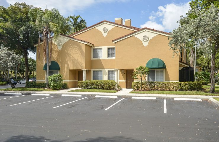 exterior photo of apartments and parking lot 