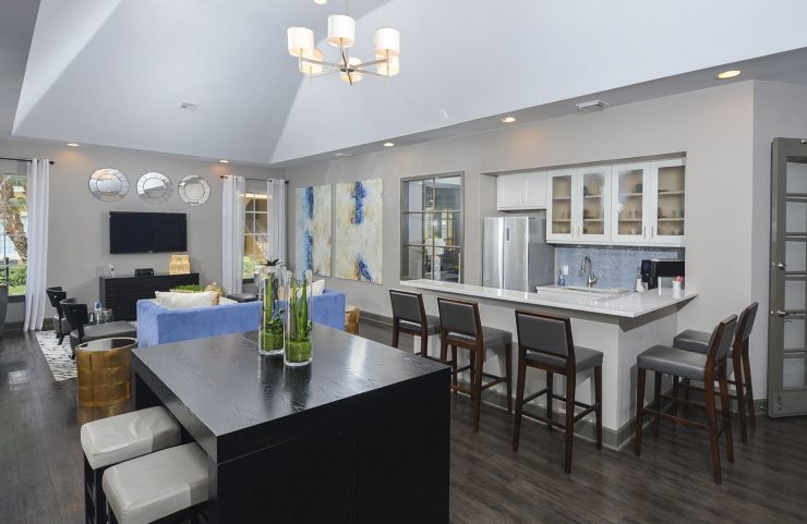 clubhouse with table seating and bar area with a fridge to entertain guests