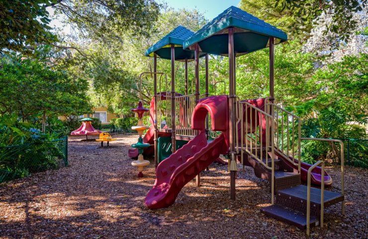 tree covered kids playground