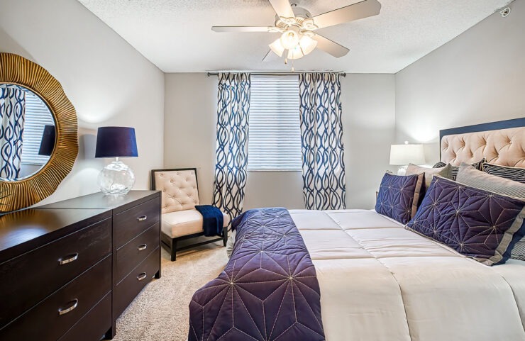 large bedroom with ceiling fan and carpet