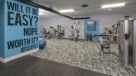 strength training equipment with motivational quotes on wall