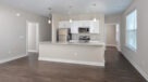 Open floorplan kitchen and living room with plank flooring and kitchen island 