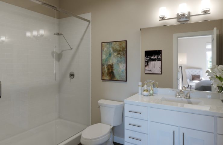 bathroom with tile shower and white vanity 