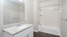 kitchen with tile tub and granite vanity 