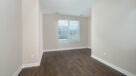 den with plank flooring in select units 