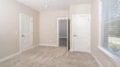 master bedroom with carpet and large closet space