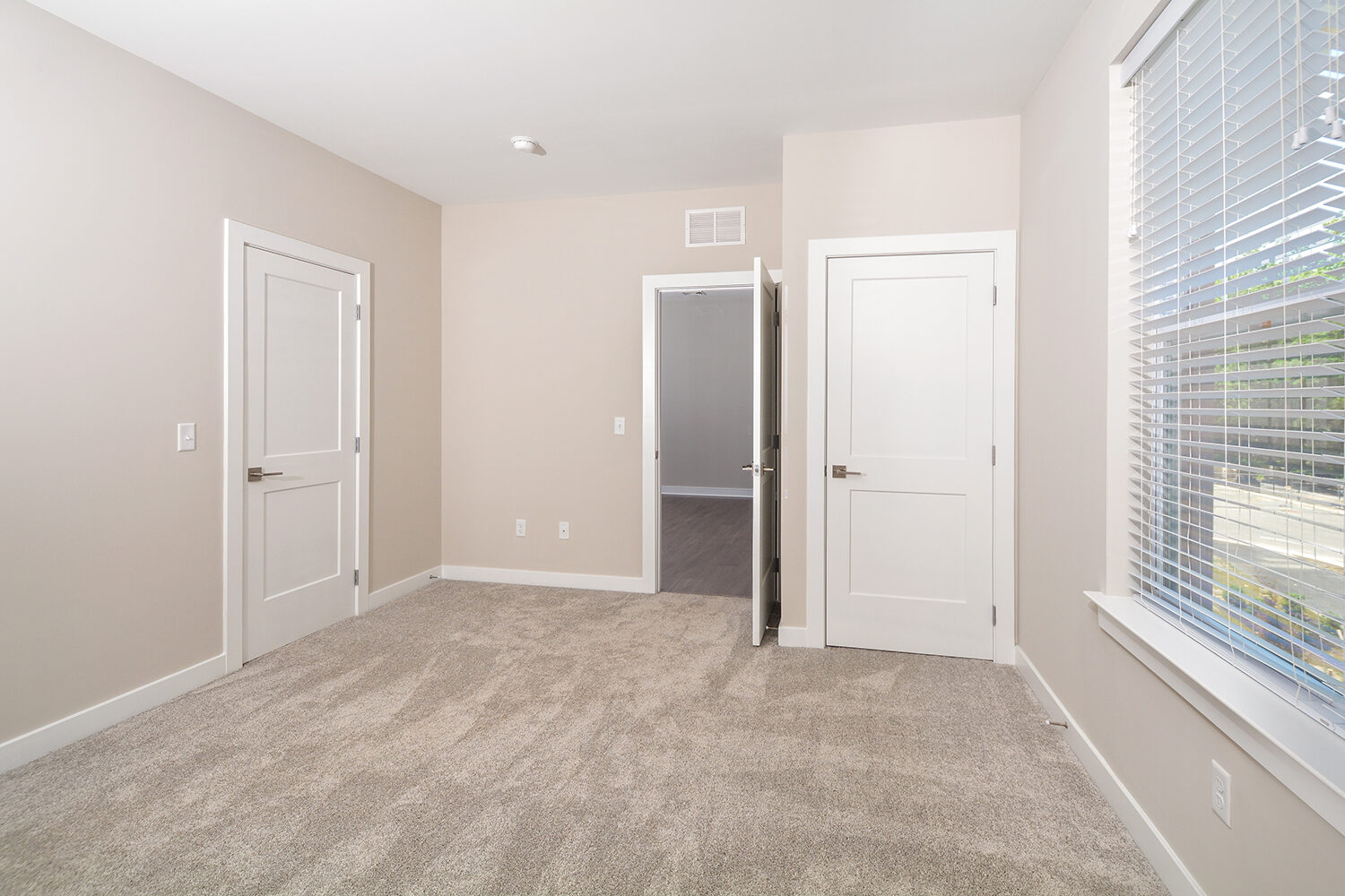 master bedroom with carpet and large closet space