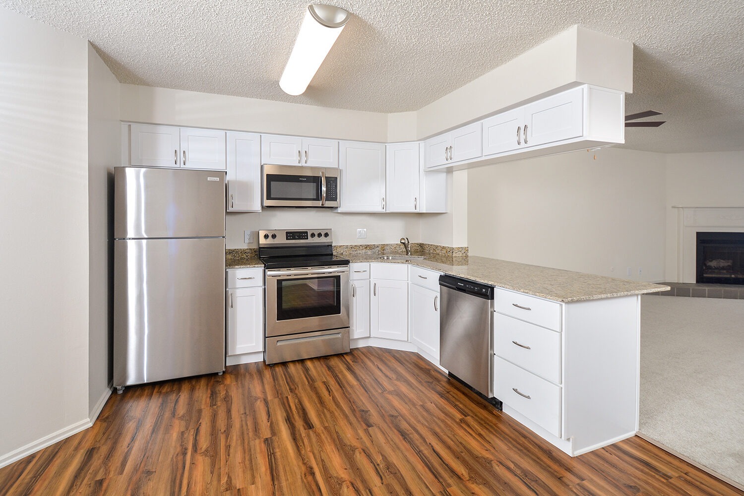 upgraded kitchen comes with white cabinets and stainless steel appliances