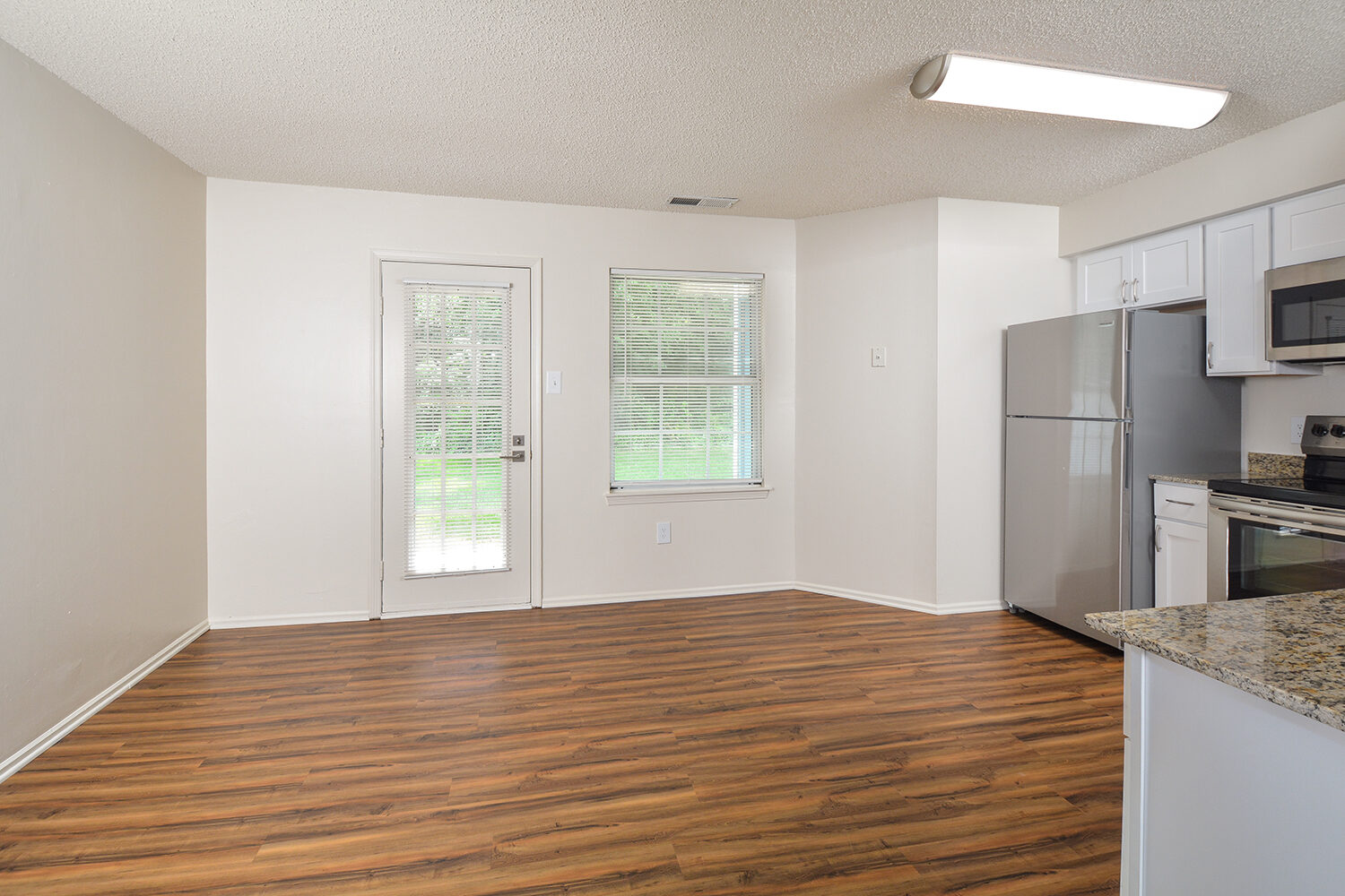 eat-in kitchen with a door leading out to an outdoor patio