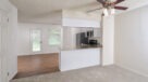 carpeted dining area outside the kitchen