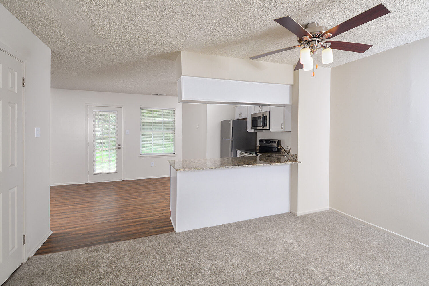 carpeted dining area outside the kitchen