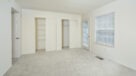 carpeted bedroom with double closets 