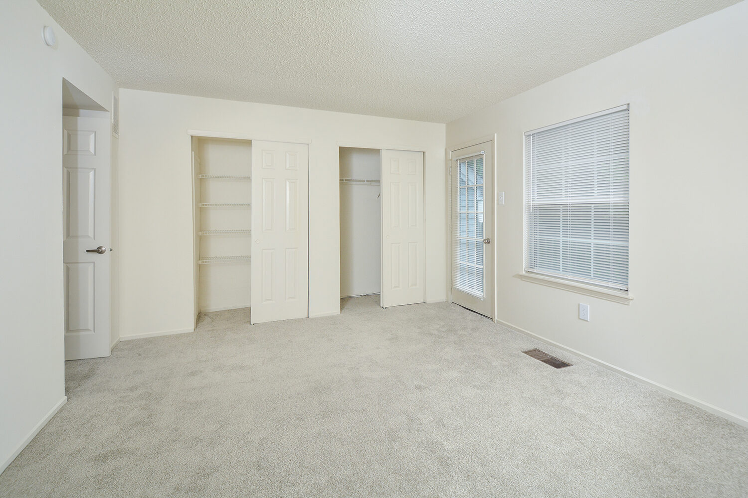 carpeted bedroom with double closets 